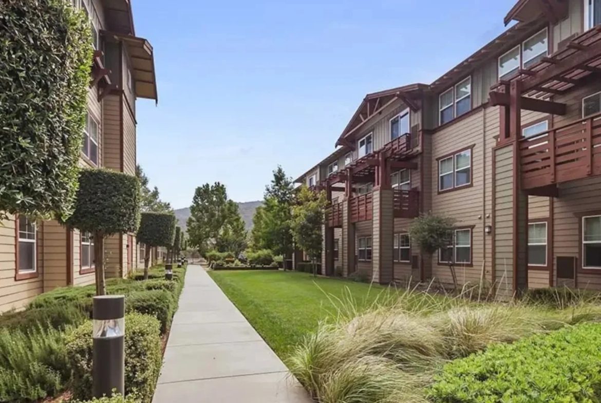 Modern apartment complex with landscaped courtyard.