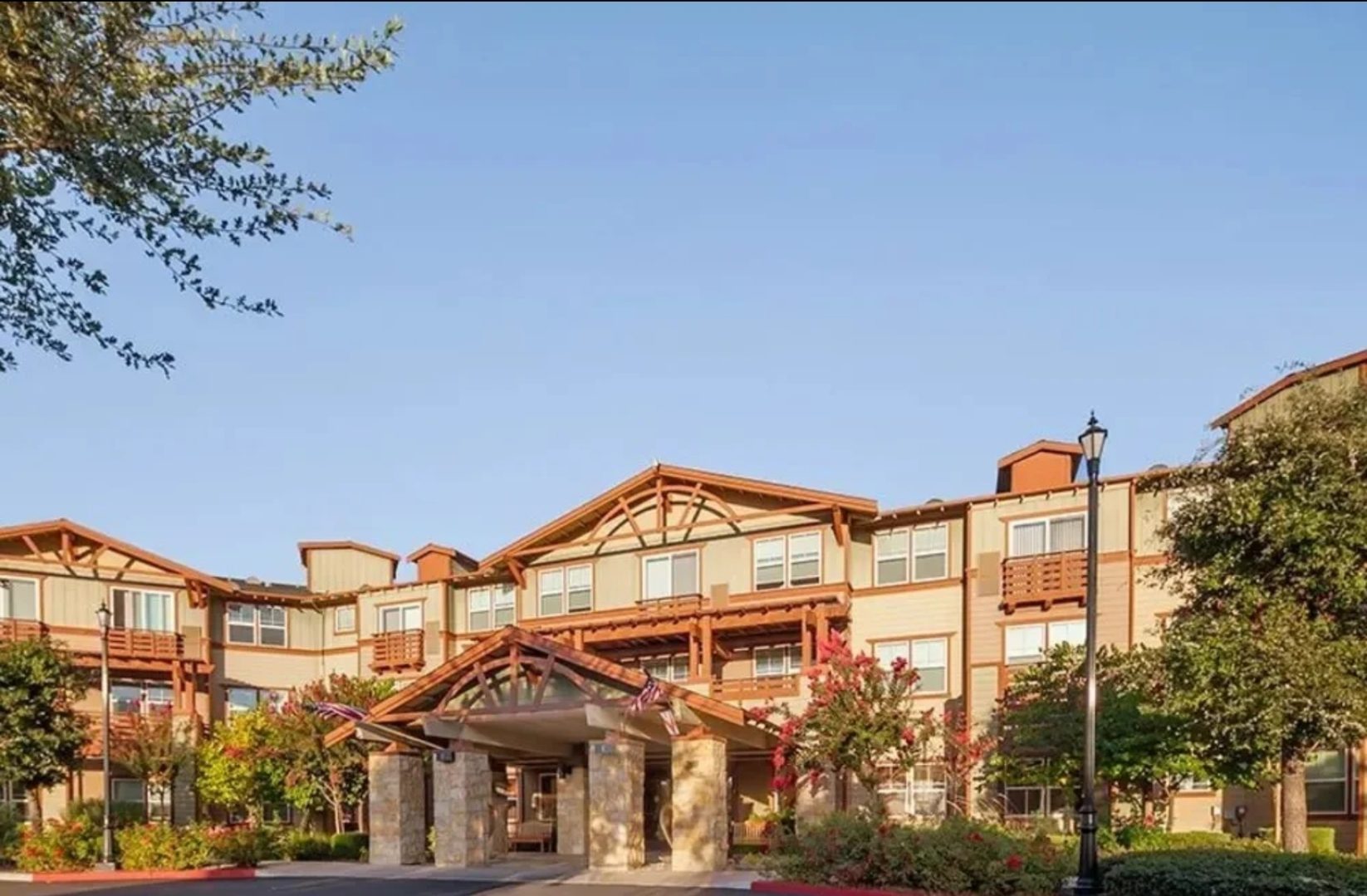 Modern multi-story building with landscaped surroundings.