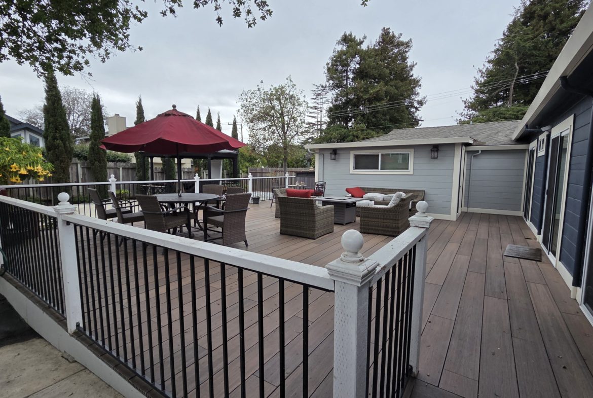 Spacious backyard deck with outdoor seating area.