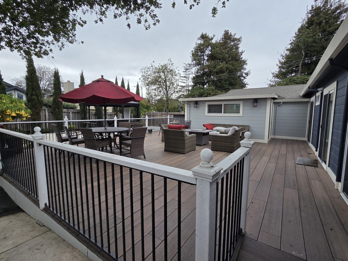 Spacious backyard deck with outdoor seating area.