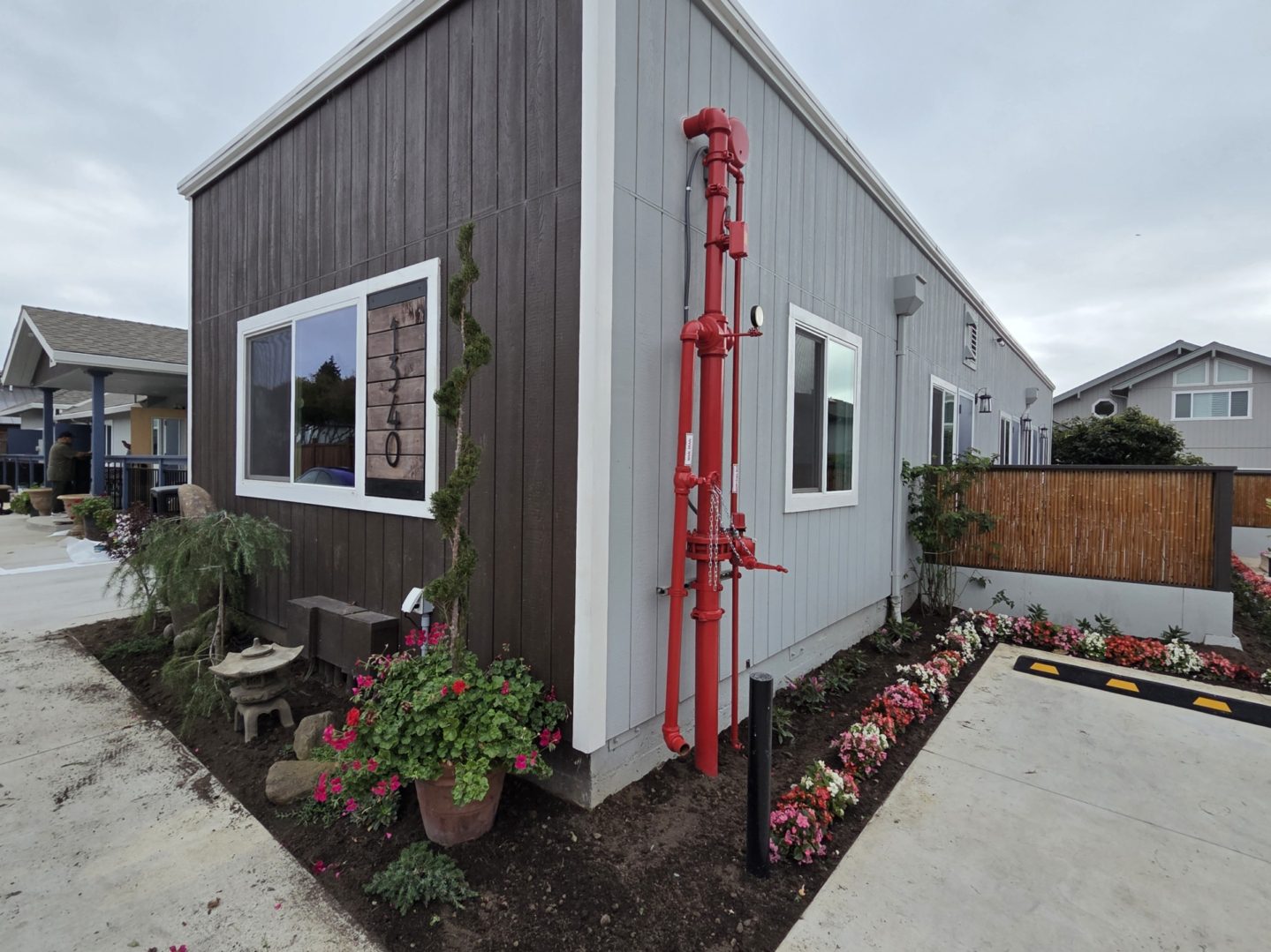 Modern house with garden and red pipes.