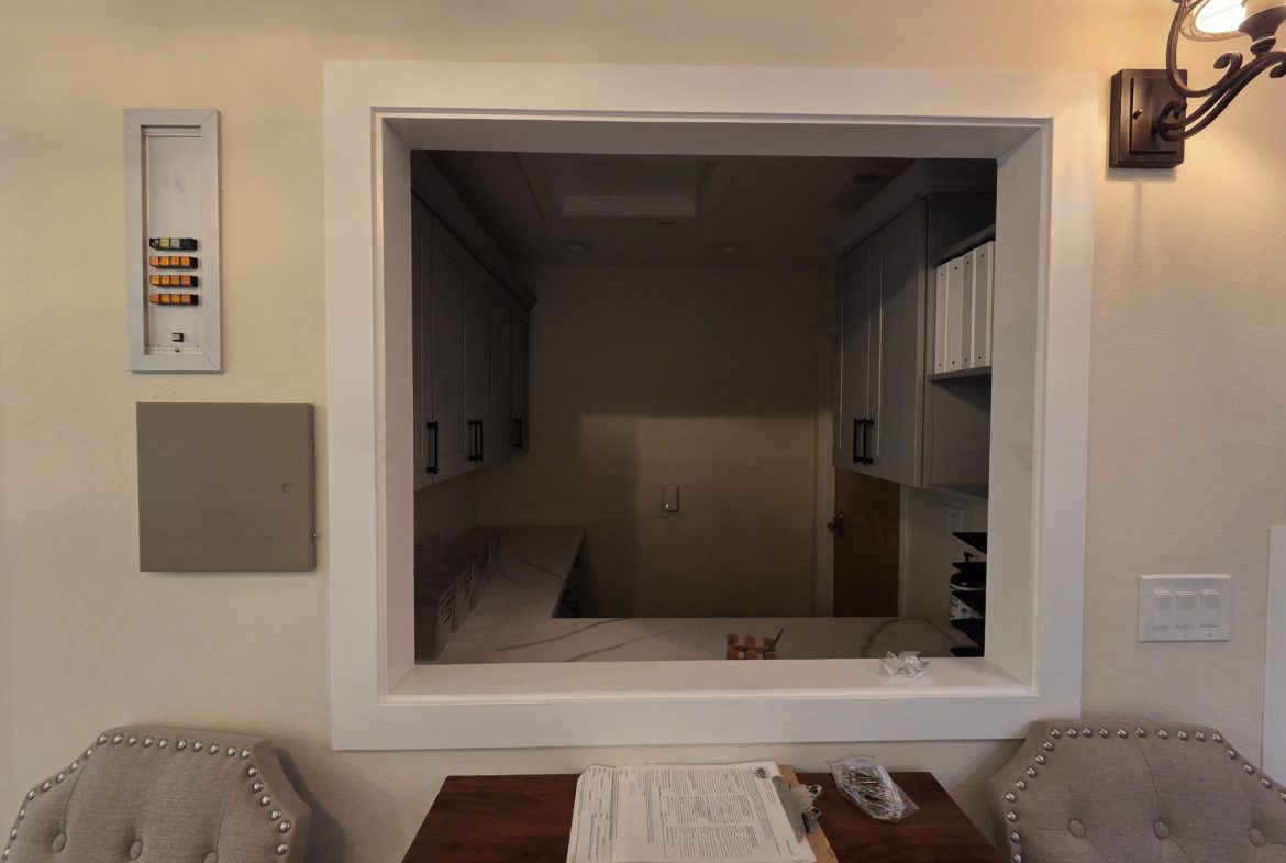 Reception window with chairs and paperwork table.