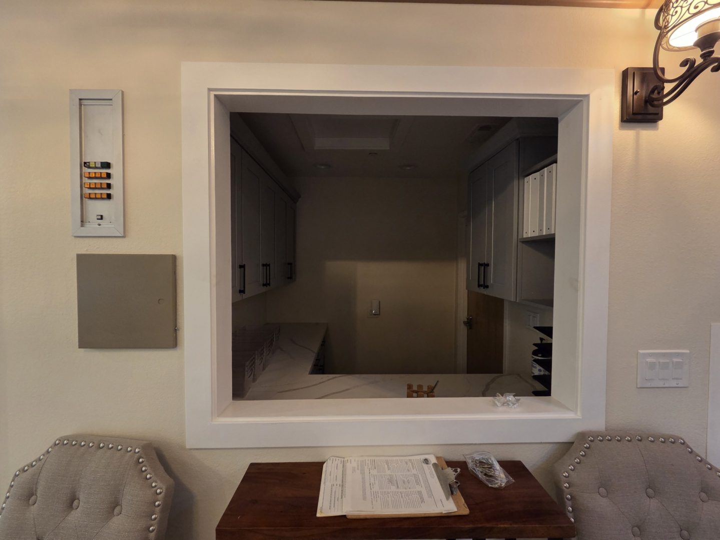 Reception window with chairs and paperwork table.