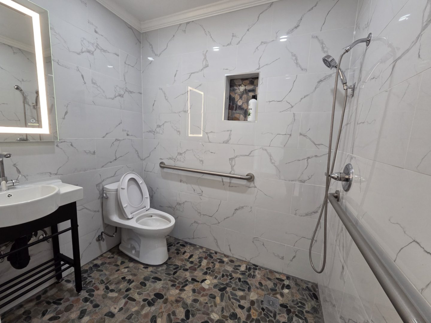 Accessible bathroom with shower and toilet.