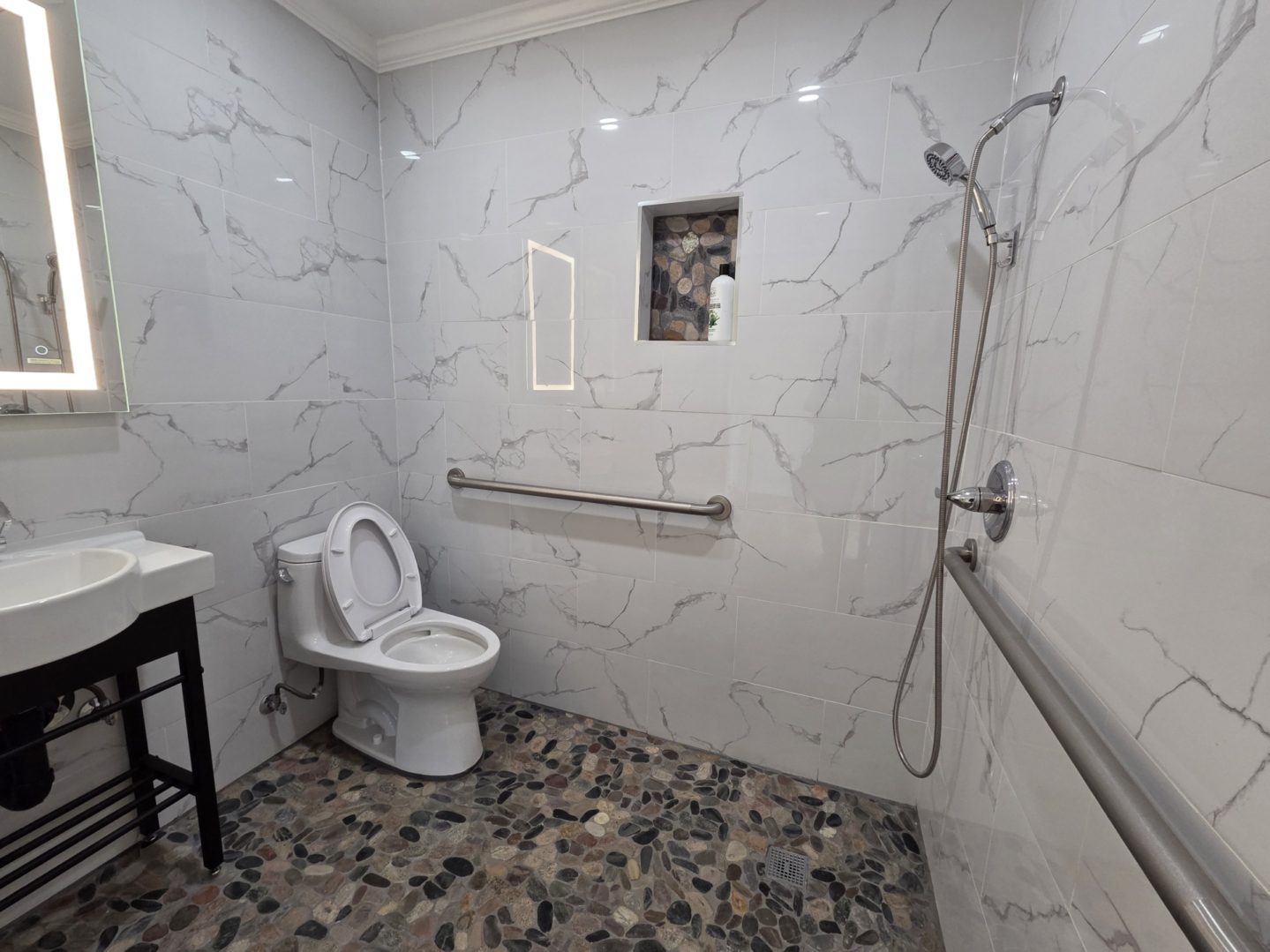 Modern accessible bathroom with shower and toilet.
