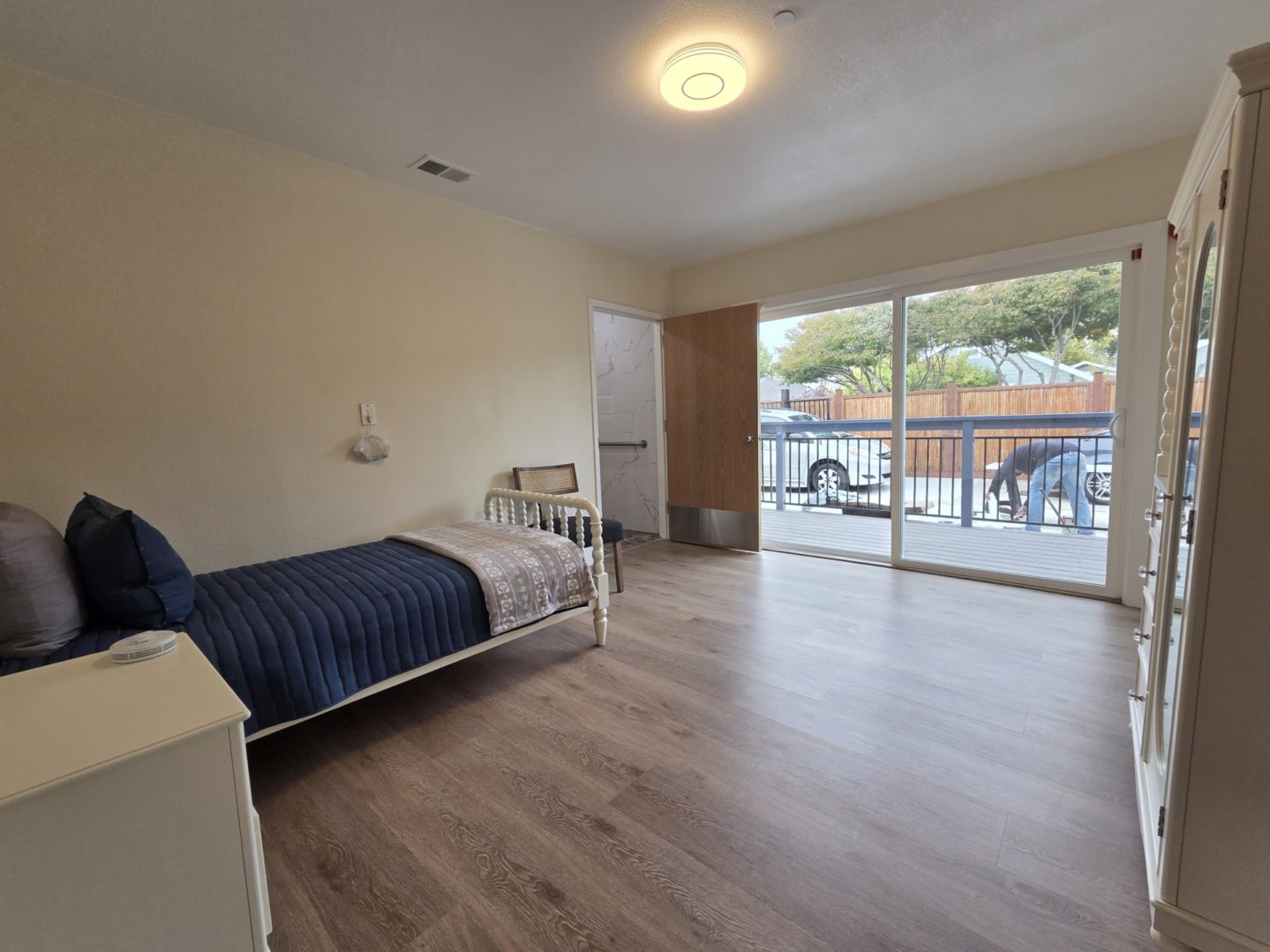 Spacious bedroom with sliding glass door.