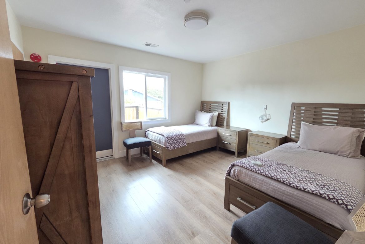 Two beds in a bright room.