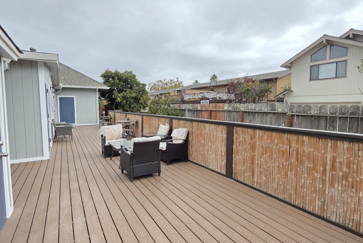 Spacious wooden deck with outdoor seating.