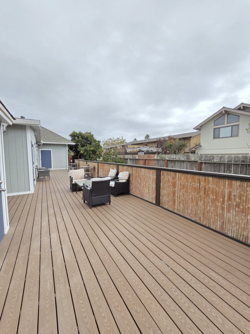 Spacious wooden deck with outdoor seating.