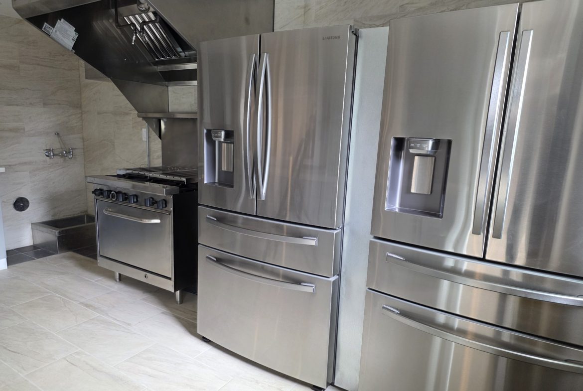 Stainless steel kitchen appliances in modern kitchen.