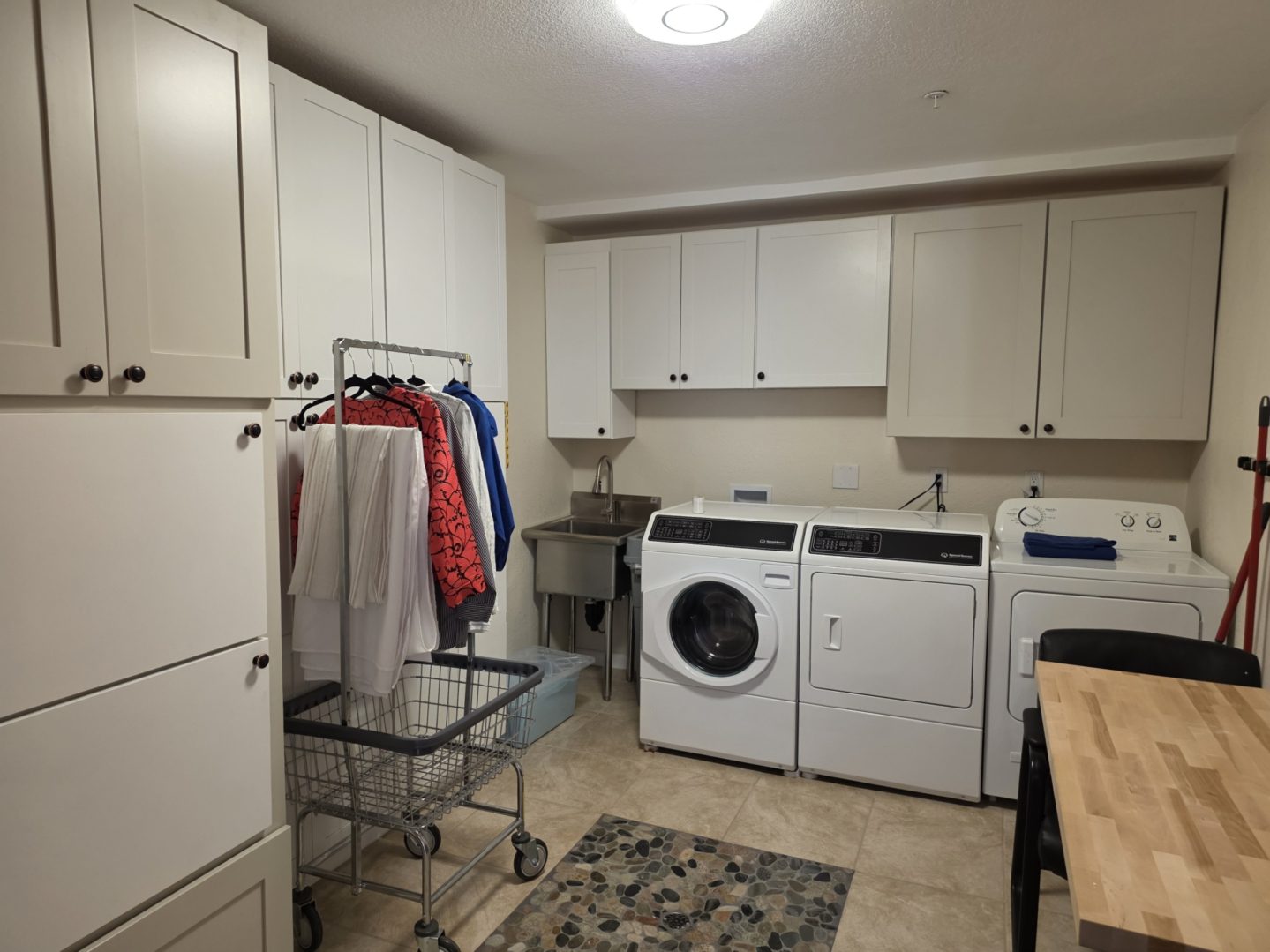 Laundry room with washer, dryer, and clothes.