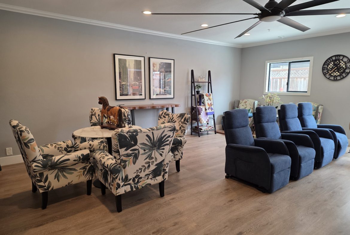 Living room with chairs and wall decor.
