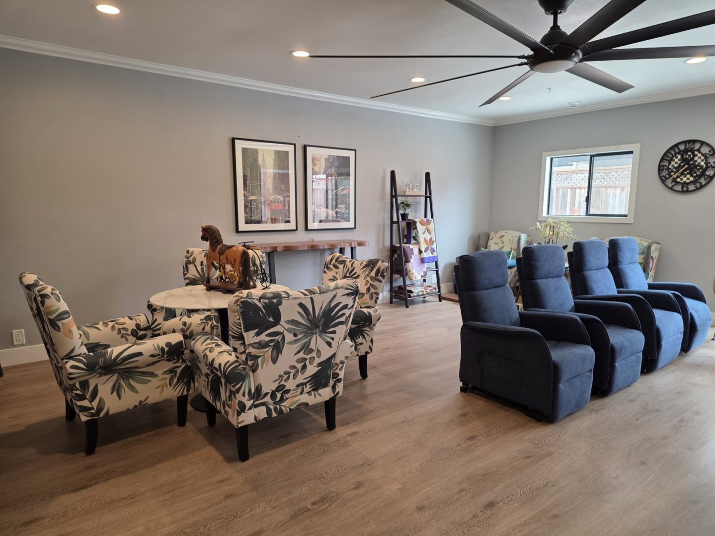 Living room with chairs and wall decor.