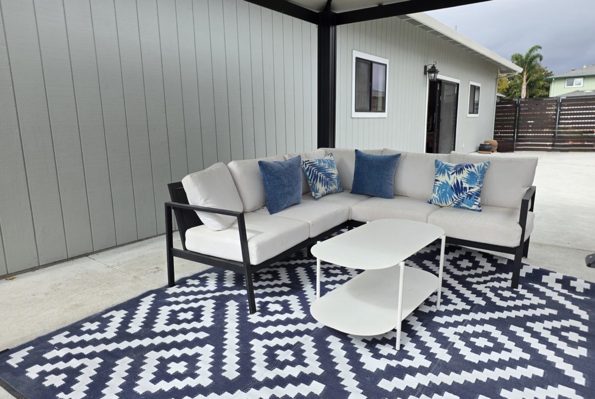 Outdoor patio with sectional sofa and table.