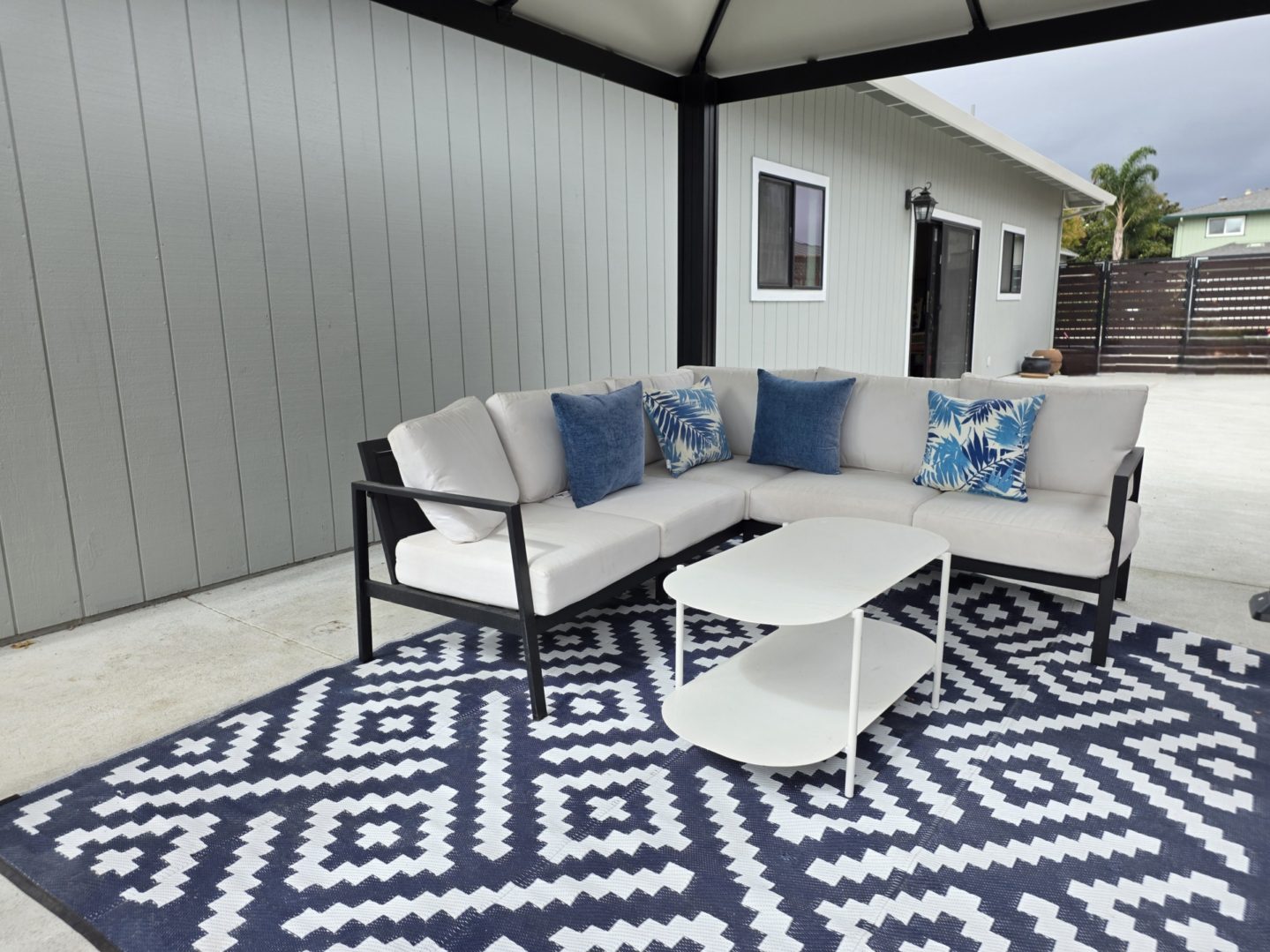 Outdoor patio with sectional sofa and table.