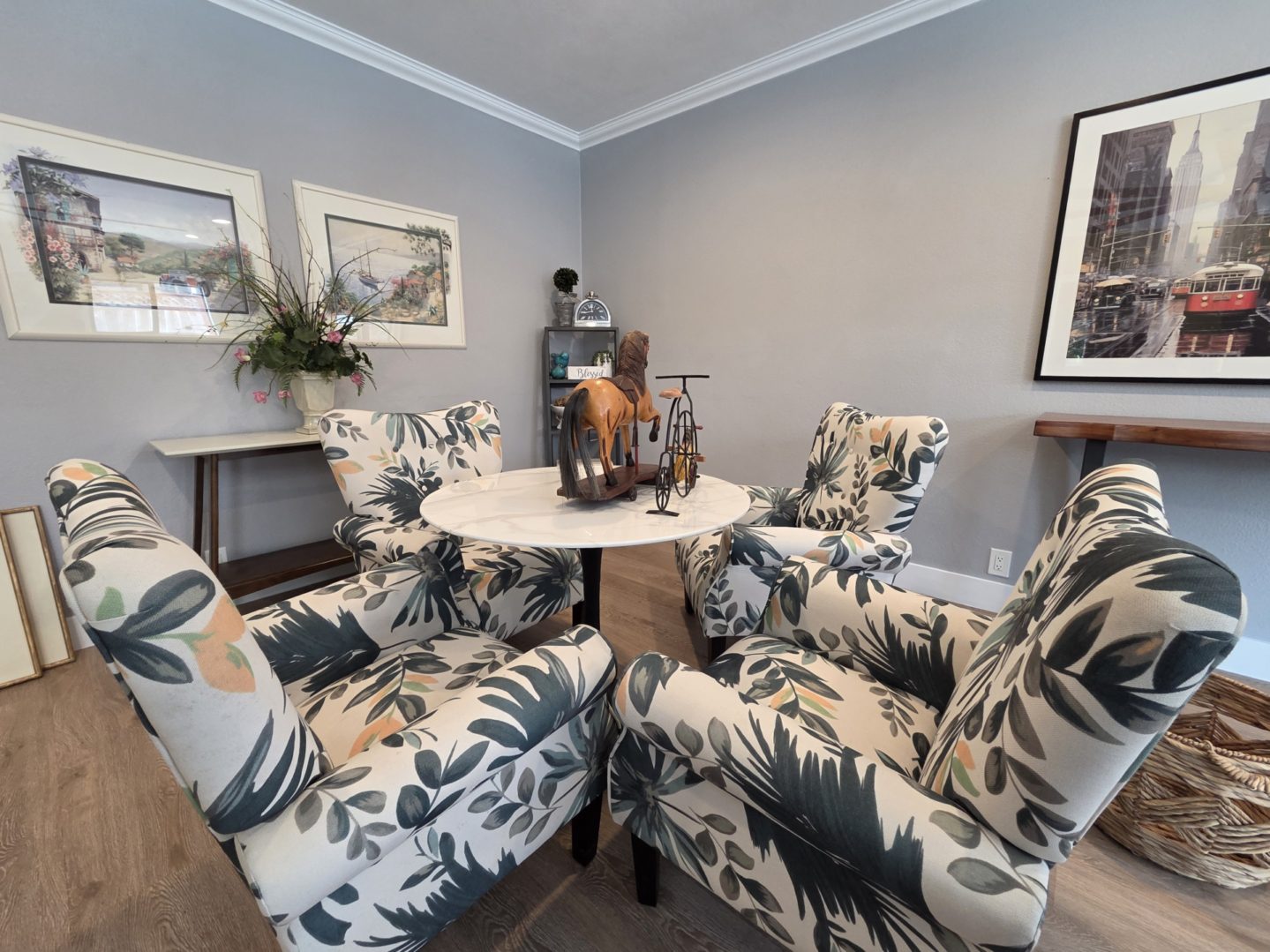 Floral chairs around a small round table.