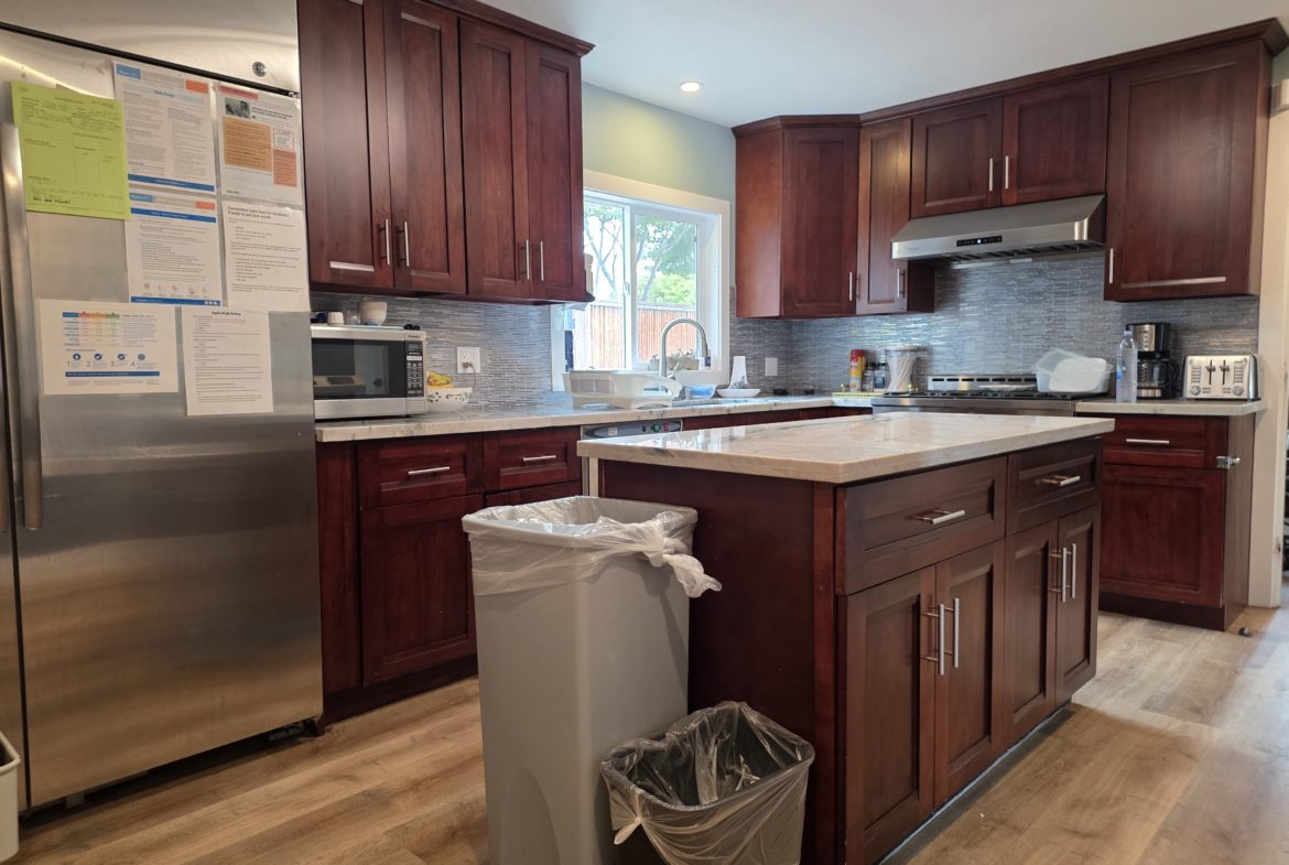 Modern kitchen with wooden cabinets and island.