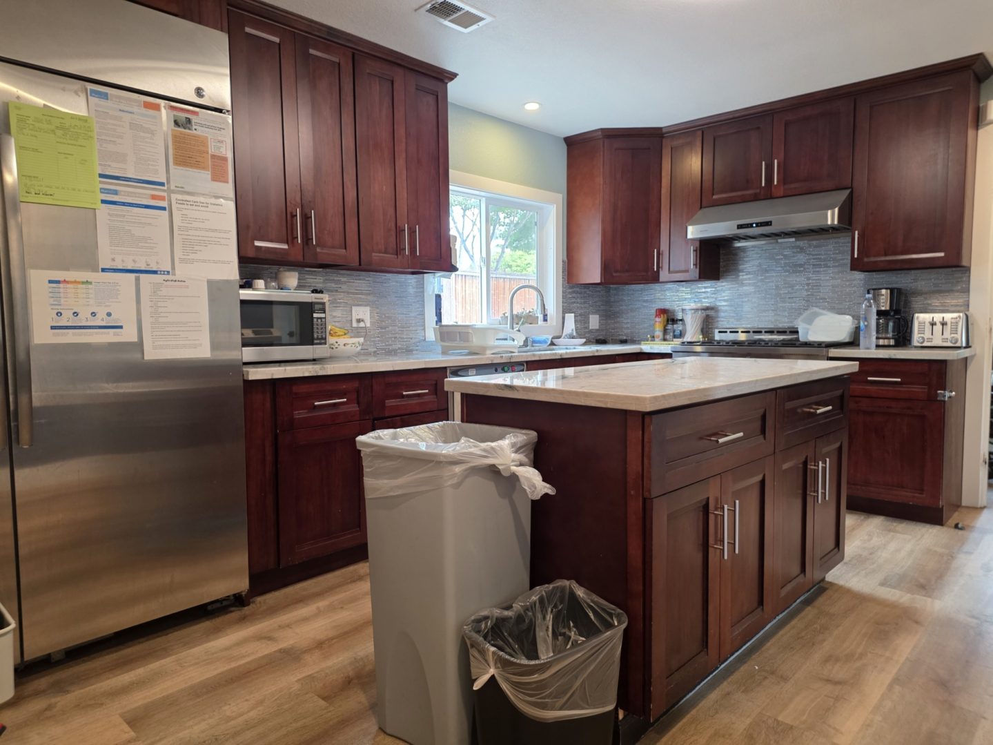 Modern kitchen with wooden cabinets and island.