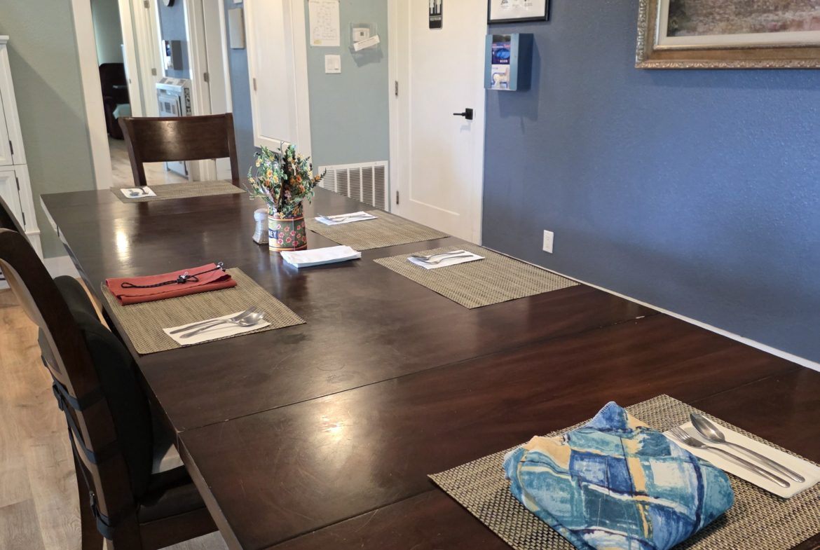 Dining room with a long wooden table.