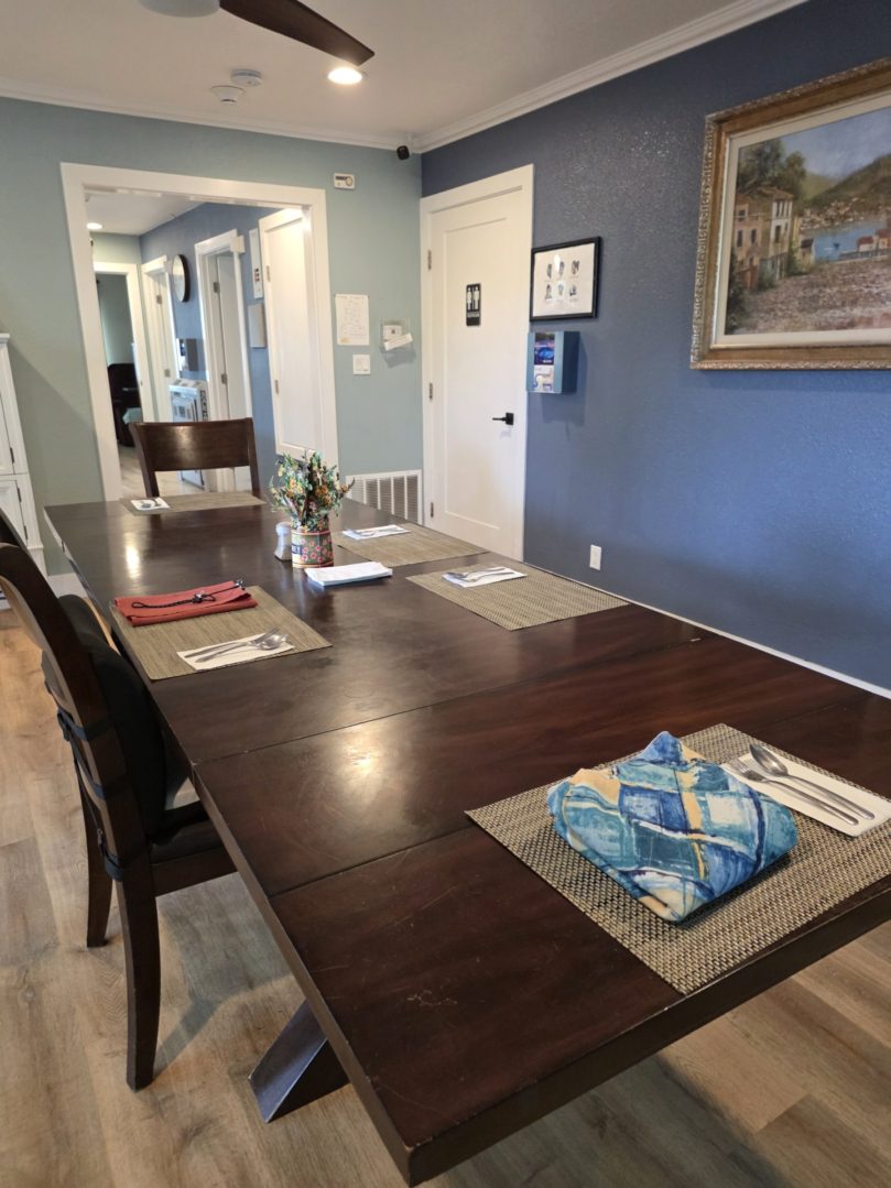 Dining room with a long wooden table.
