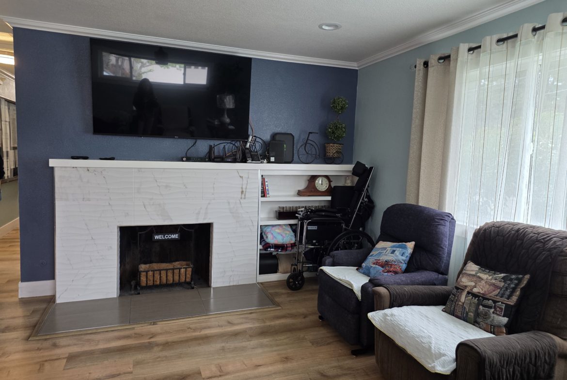 Living room with fireplace and armchairs.