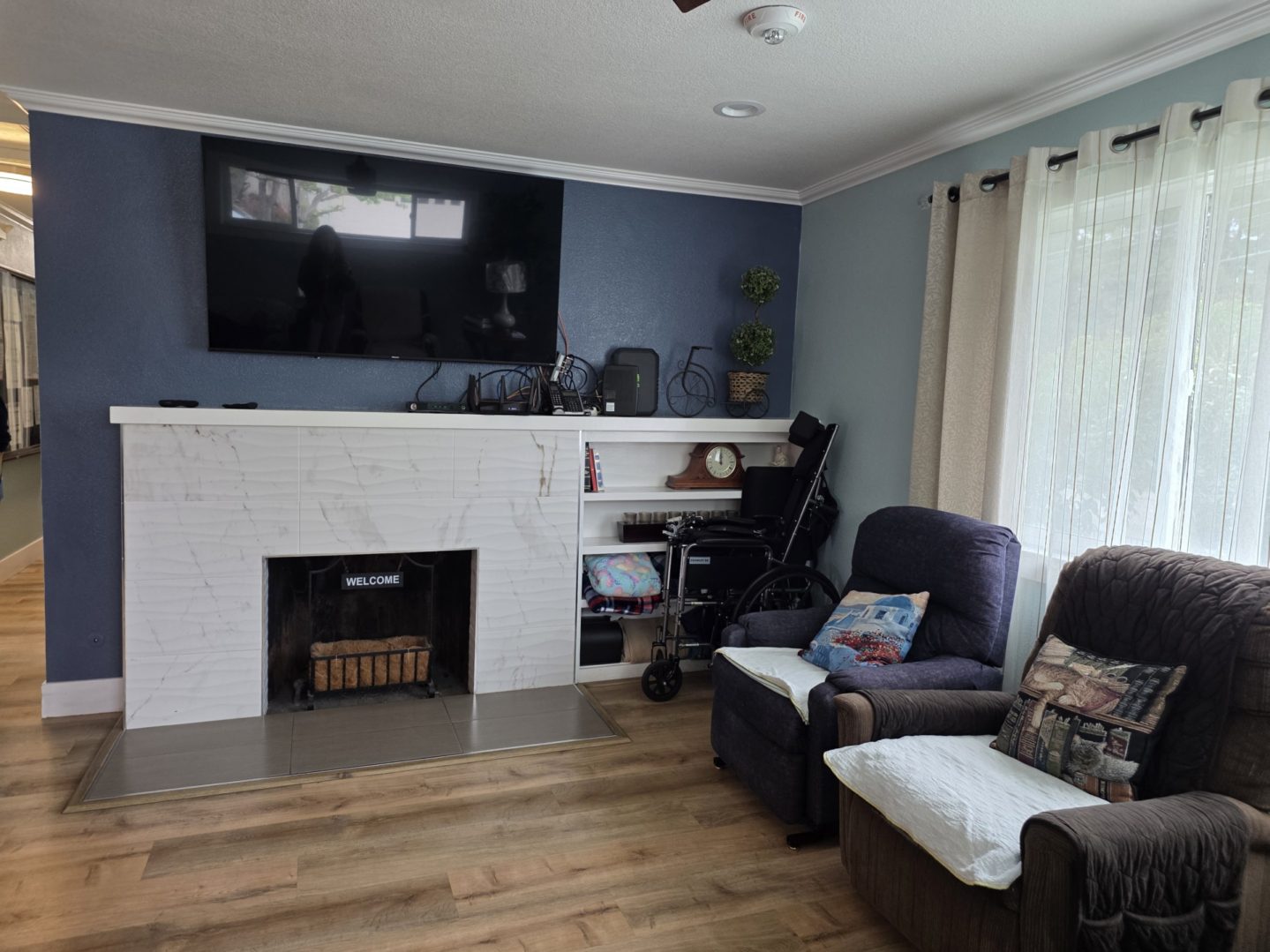 Living room with fireplace and armchairs.