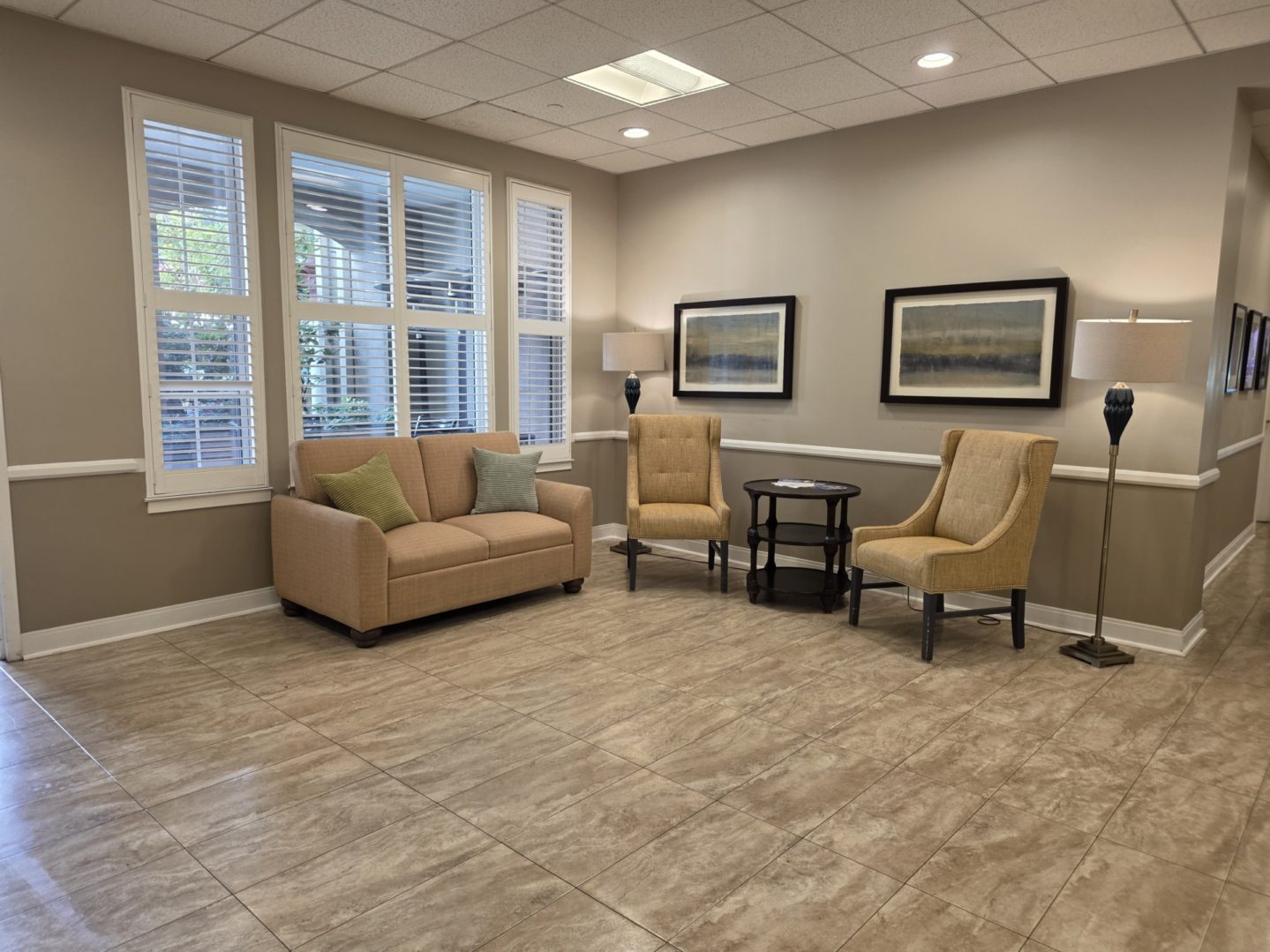 Cozy waiting area with chairs and sofa.