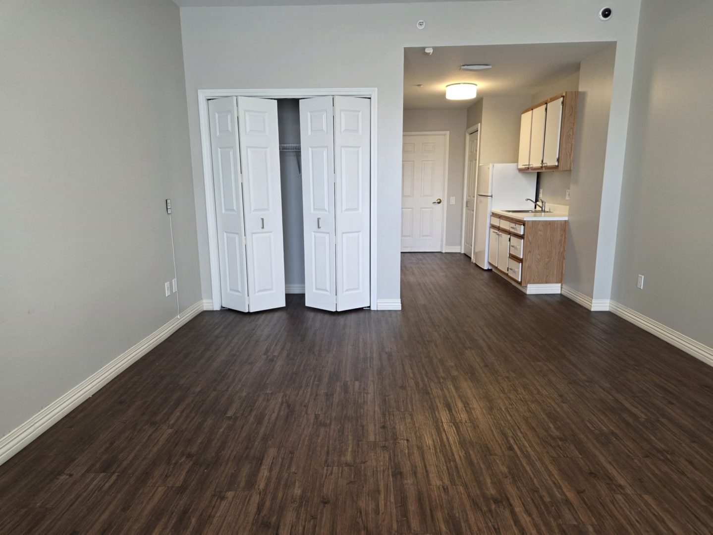 Empty room with wood floor and closet.