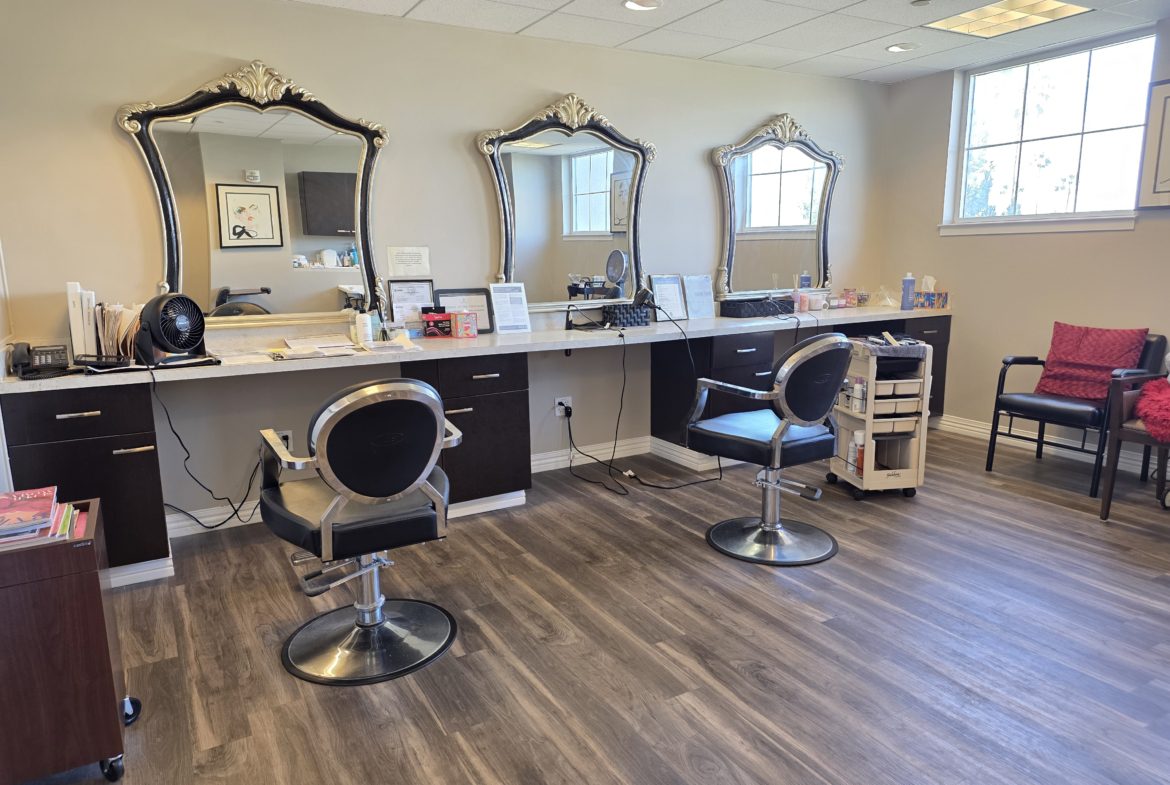Hair salon with chairs and mirrors.