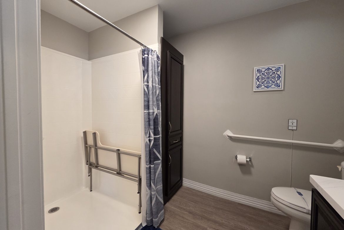 Accessible bathroom with shower and grab bars.