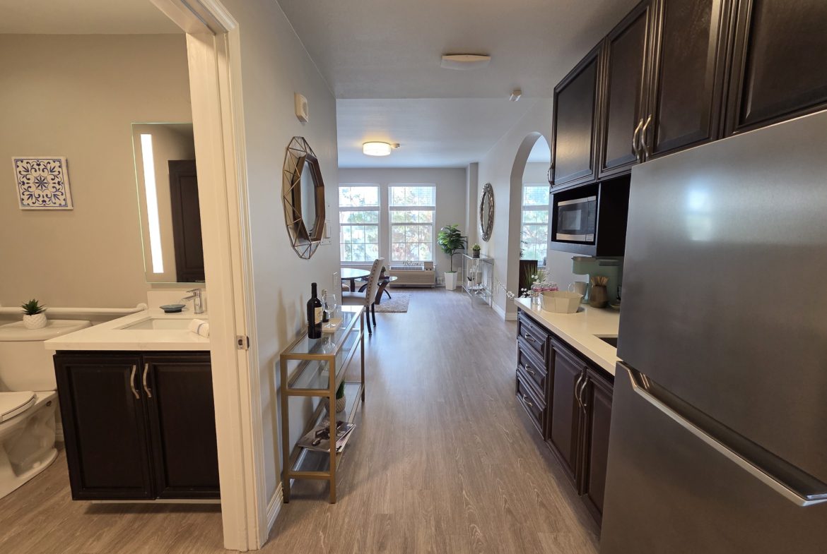 Modern kitchen and living area with decor.