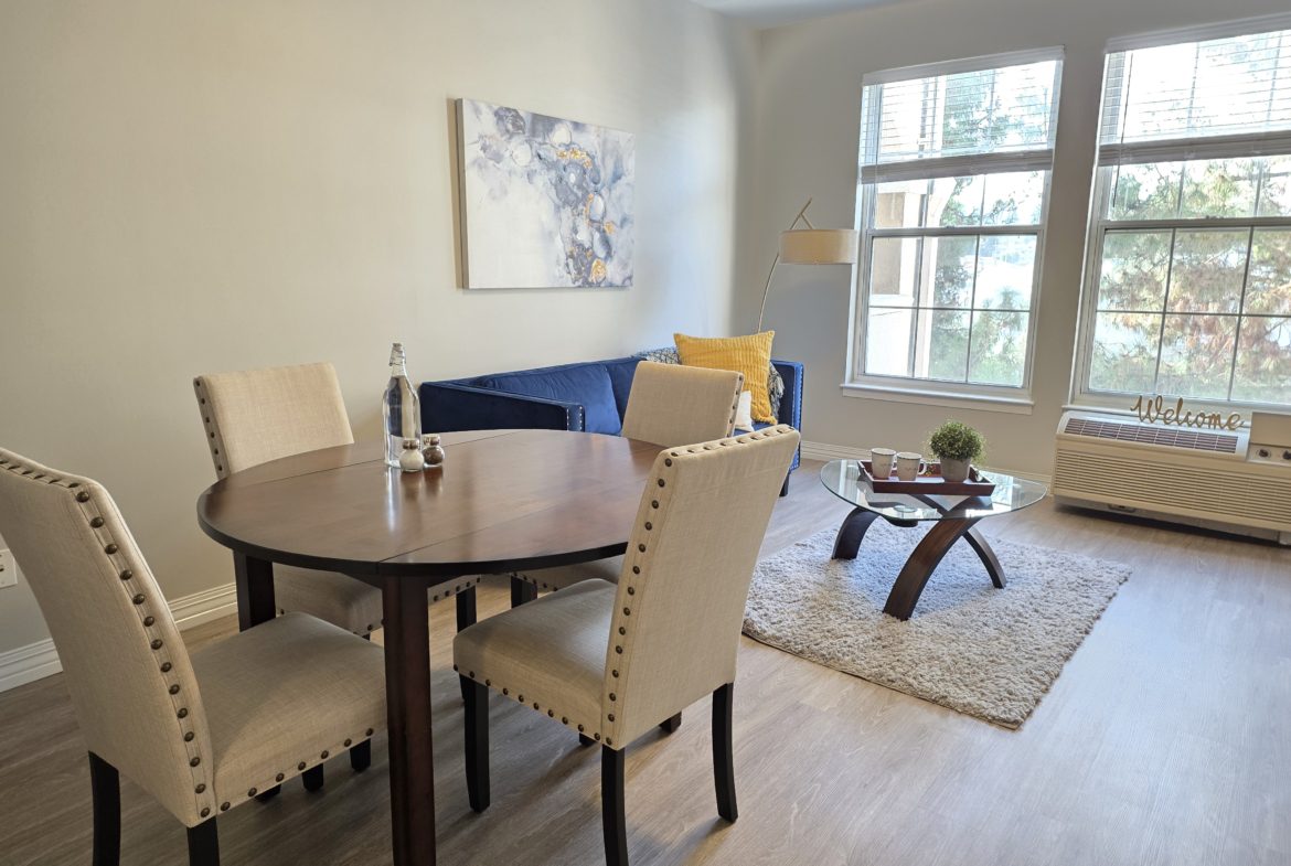 Cozy dining and living room with windows.