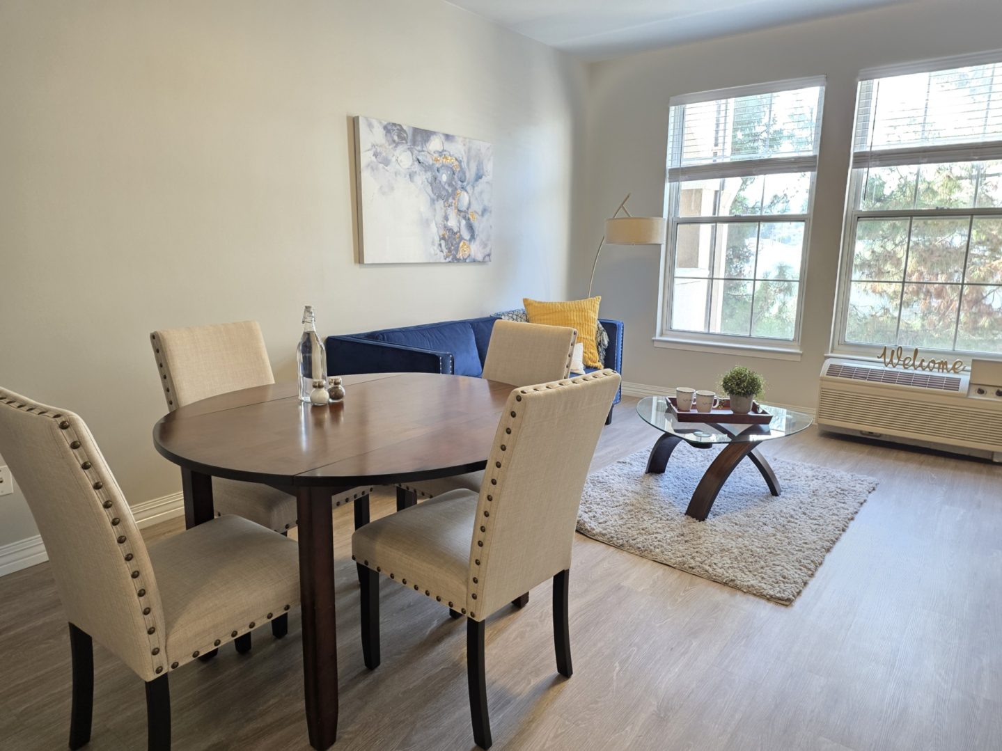 Cozy dining and living room with windows.