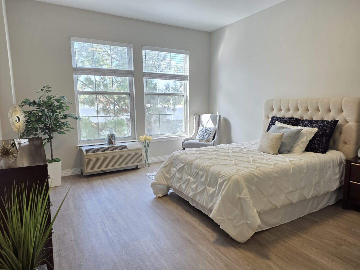 Bright bedroom with large window and bed.