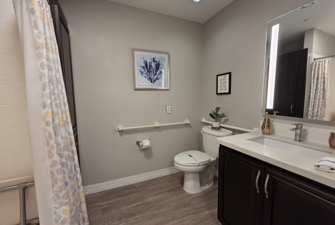 Modern bathroom with shower and vanity.