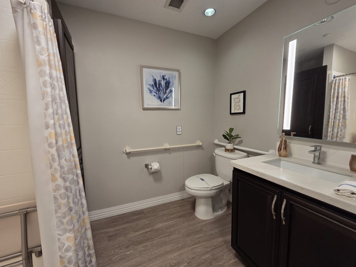Modern bathroom with shower and vanity.