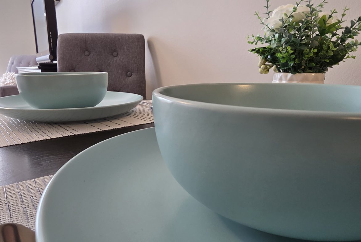 Dining table with blue plates and bowls.