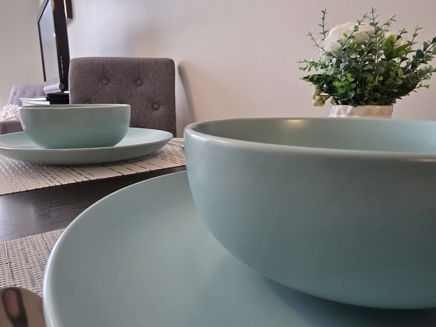 Dining table with blue plates and bowls.