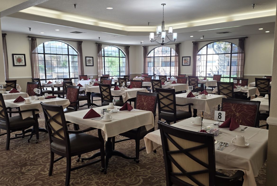 Elegant dining room with arranged tables and chairs.