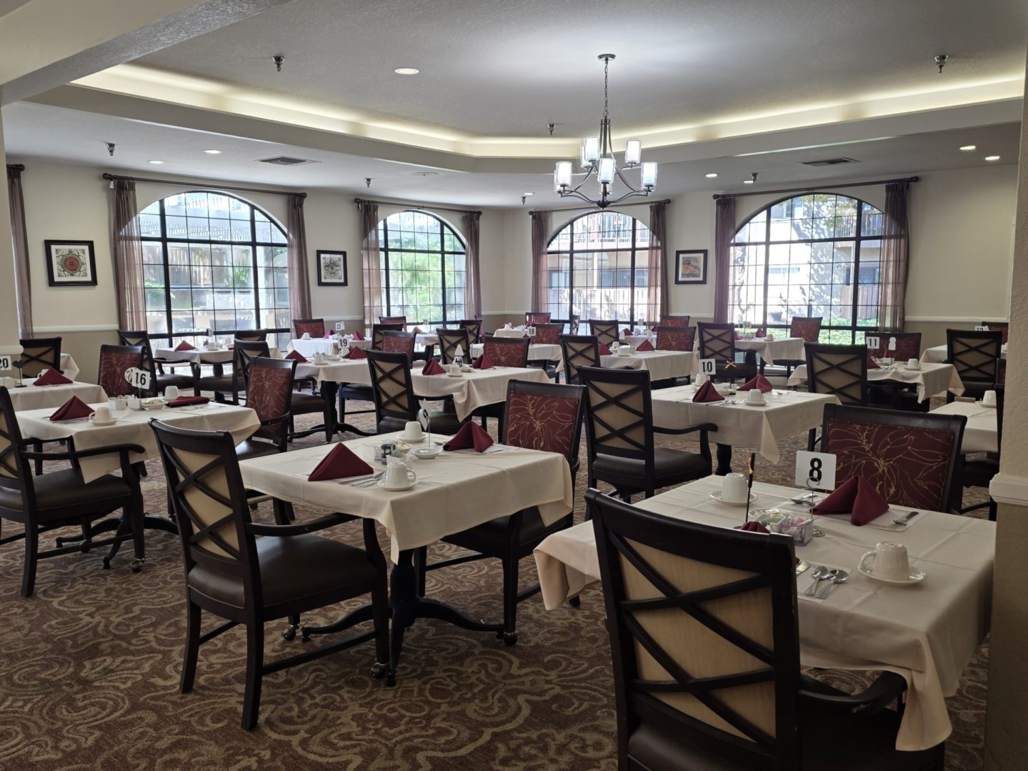 Elegant dining room with arranged tables and chairs.