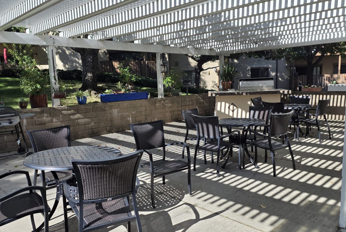 Outdoor patio with tables and chairs.