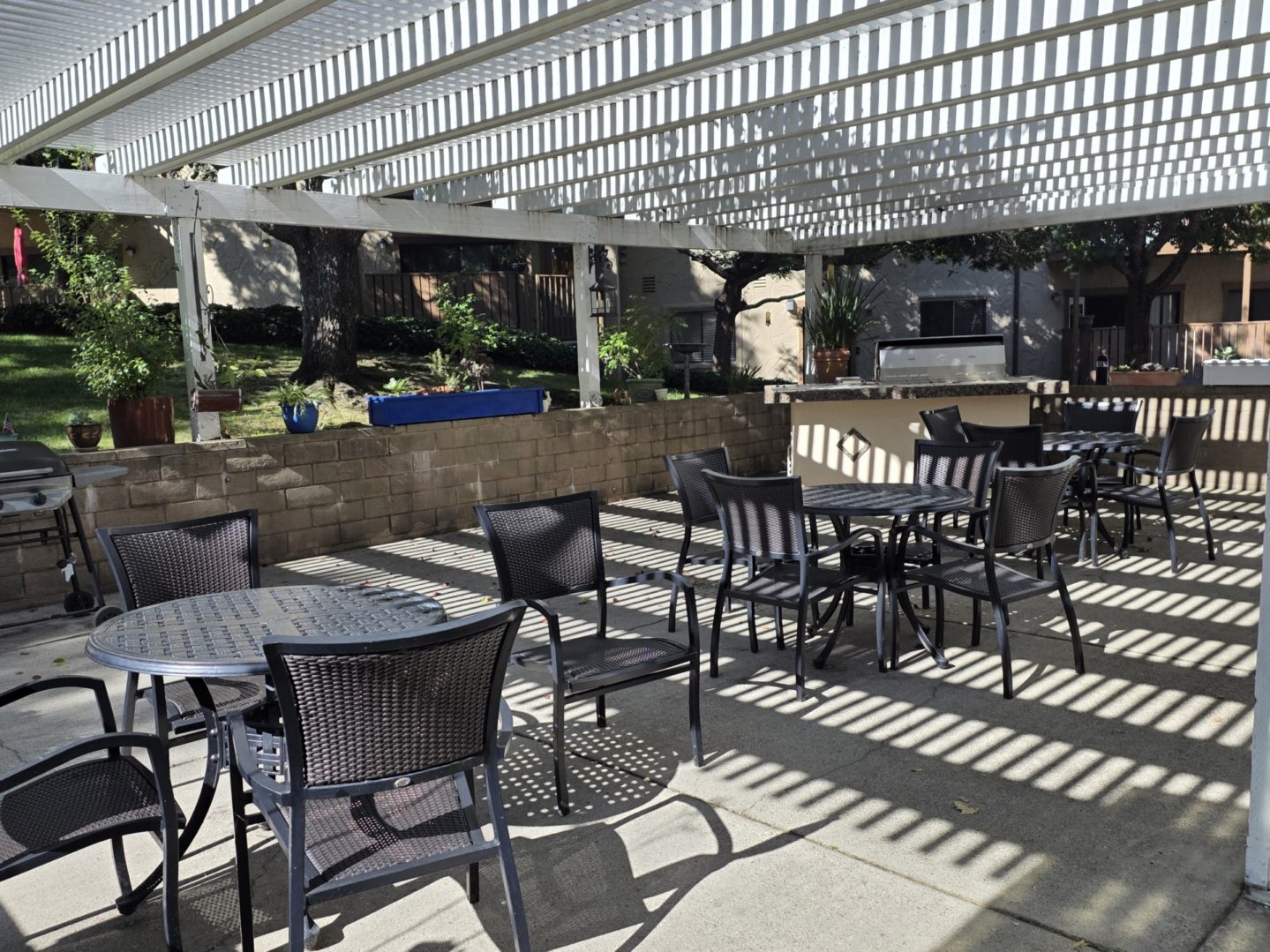 Outdoor patio with tables and chairs.