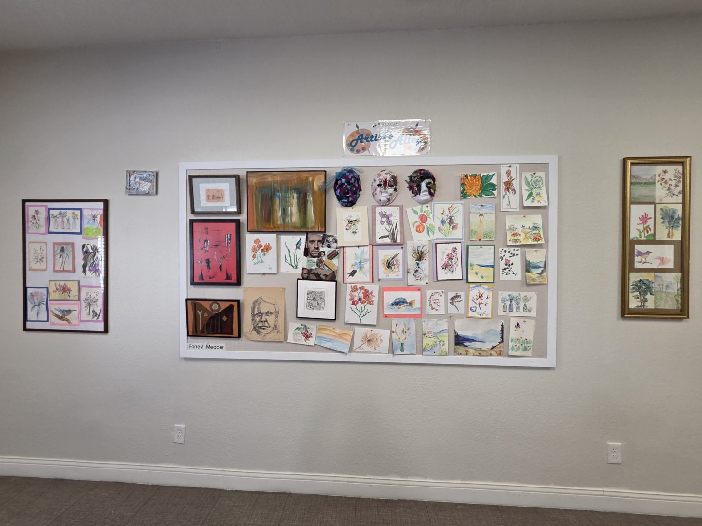 Art display with various paintings and drawings.