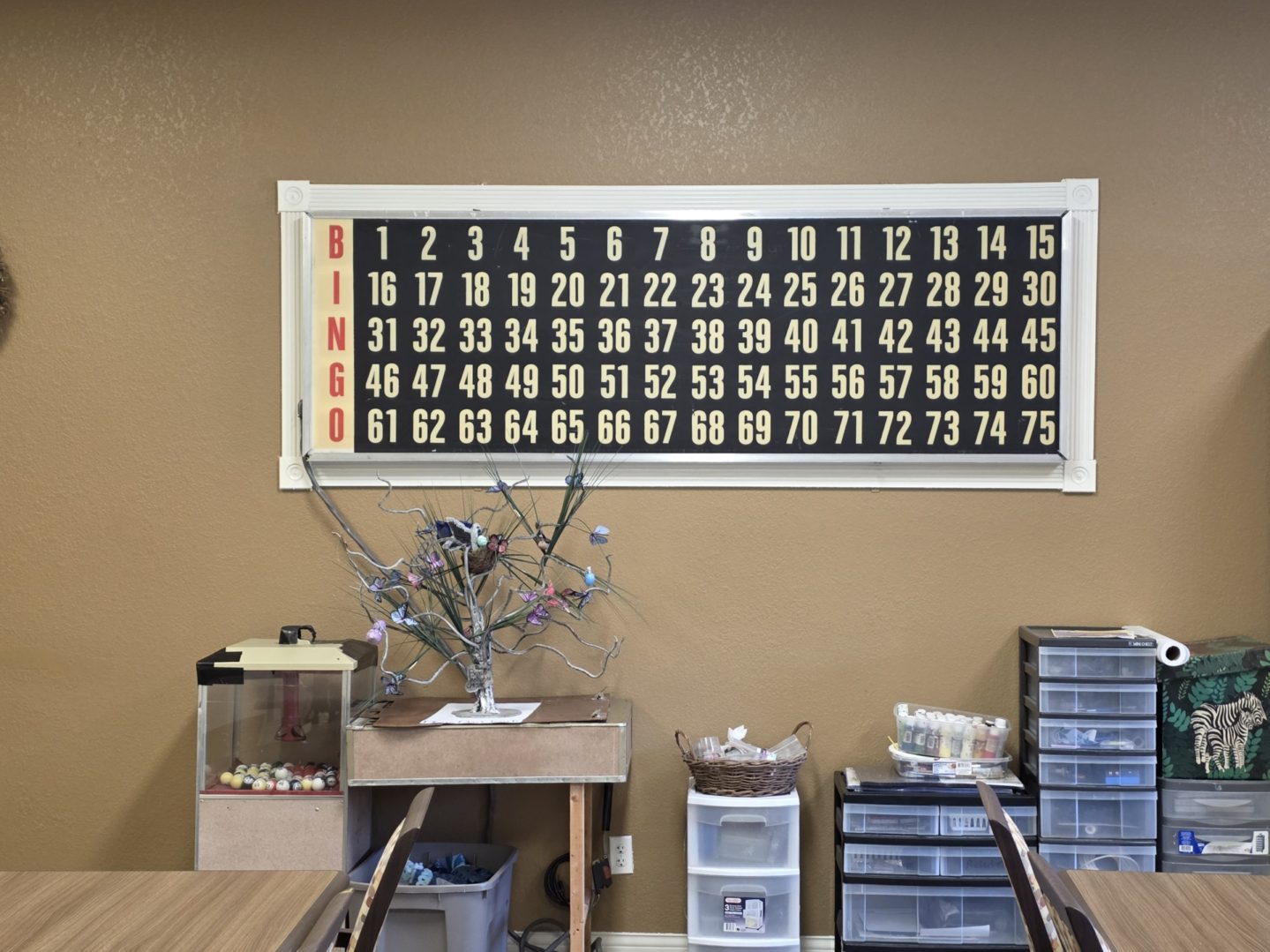 Bingo board on wall with decorations below.