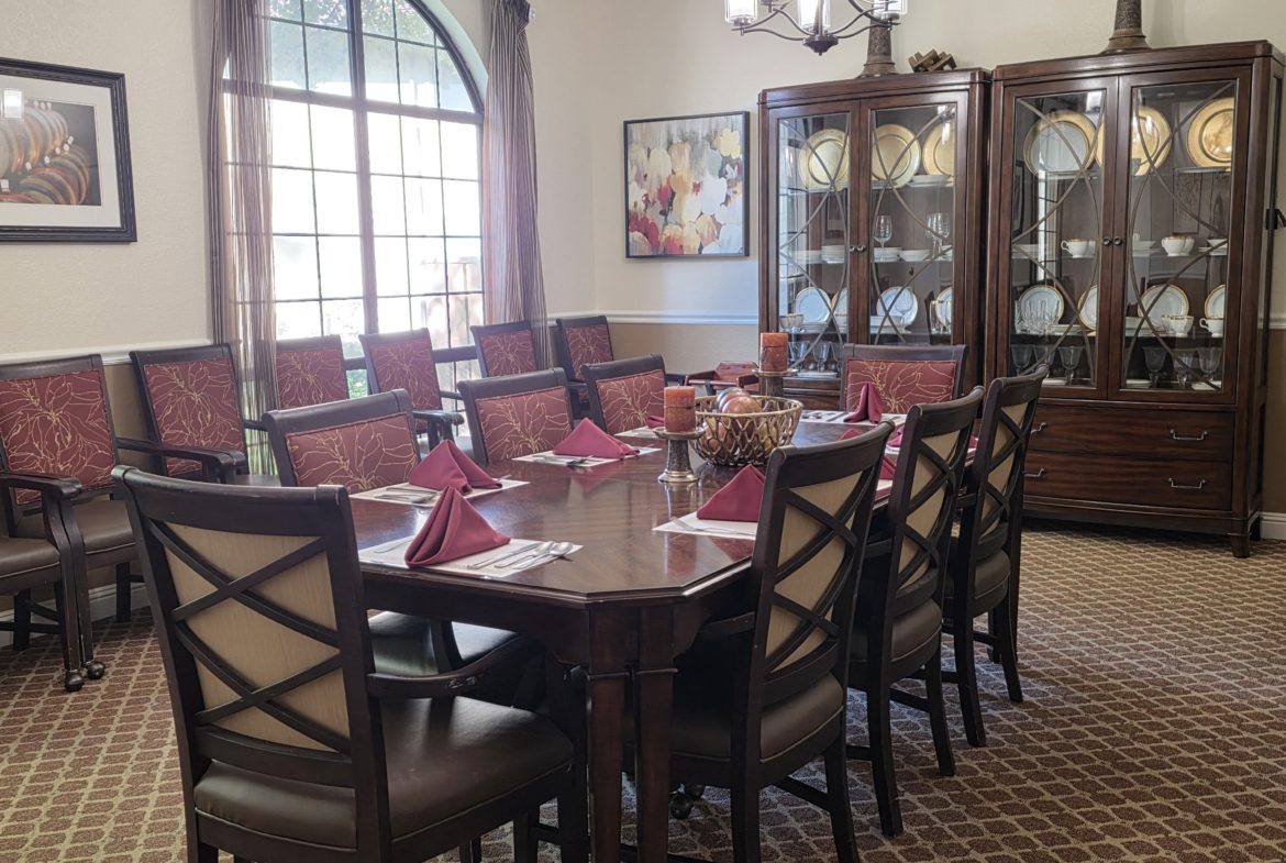 Elegant dining room with large wooden table.