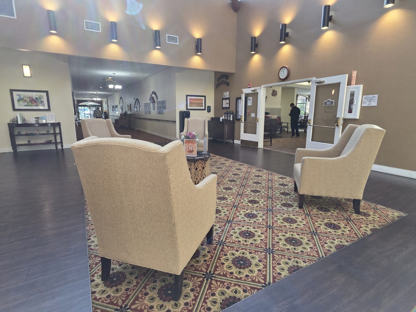 Lobby with armchairs and patterned carpet.
