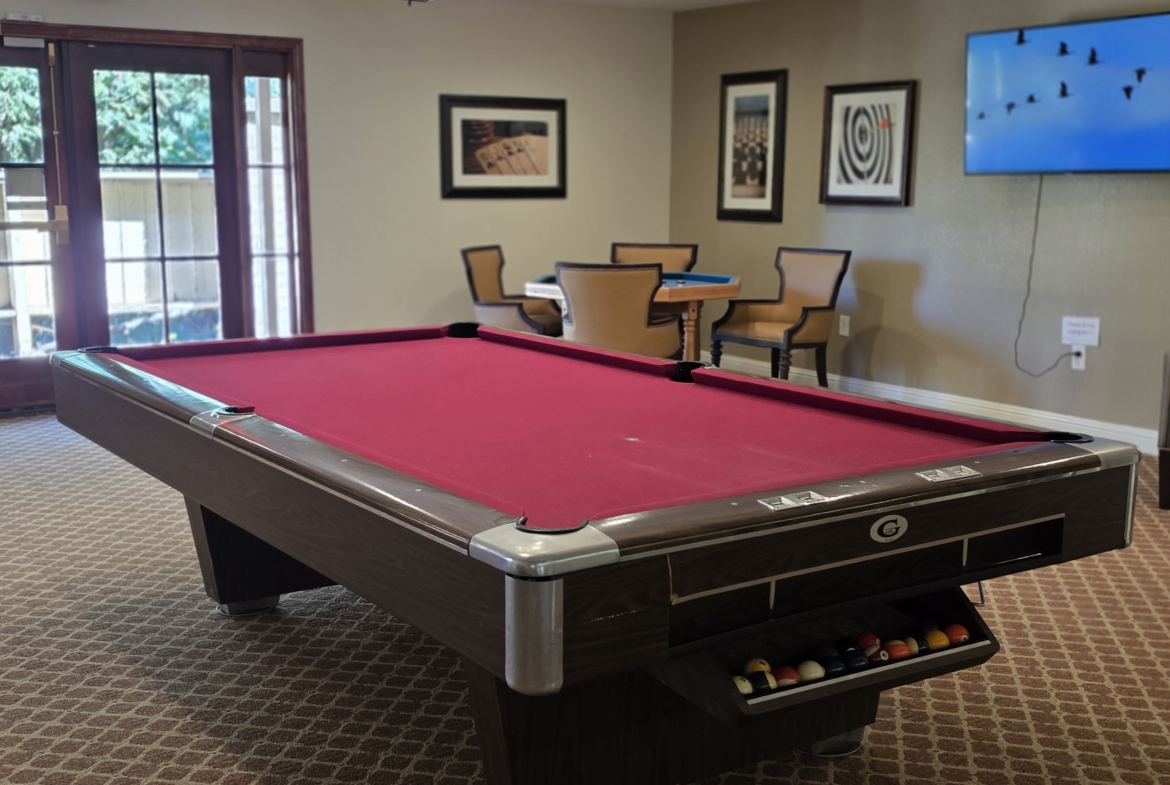 Red pool table in a recreational room.