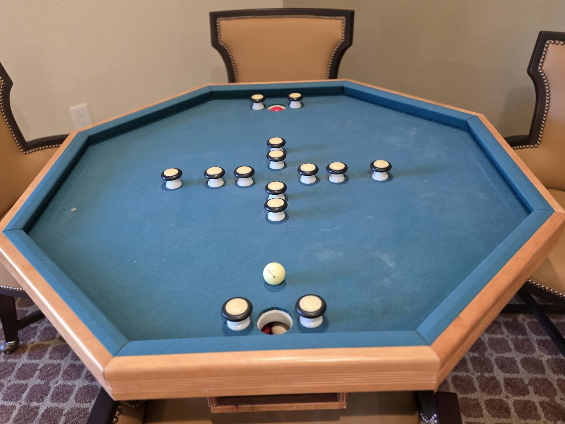 Hexagonal table with pegs and holes.