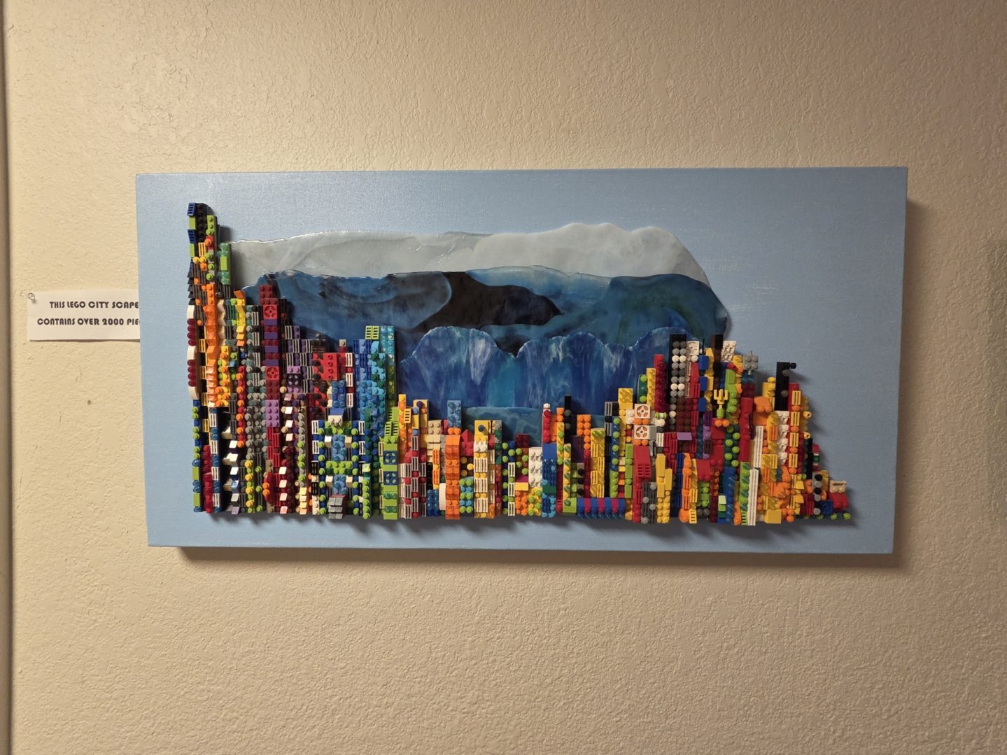 Colorful cityscape artwork with abstract mountain.